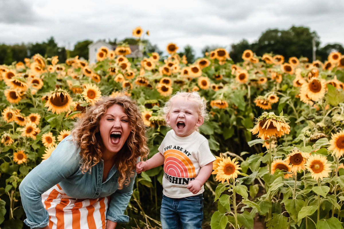 Large Sunflower field with boden striped skirt toddler photo shoot in massive sunflower