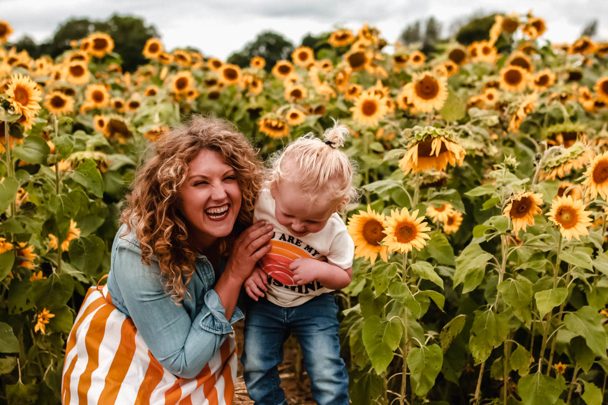Large Sunflower field with boden striped skirt toddler photo shoot in massive sunflower 