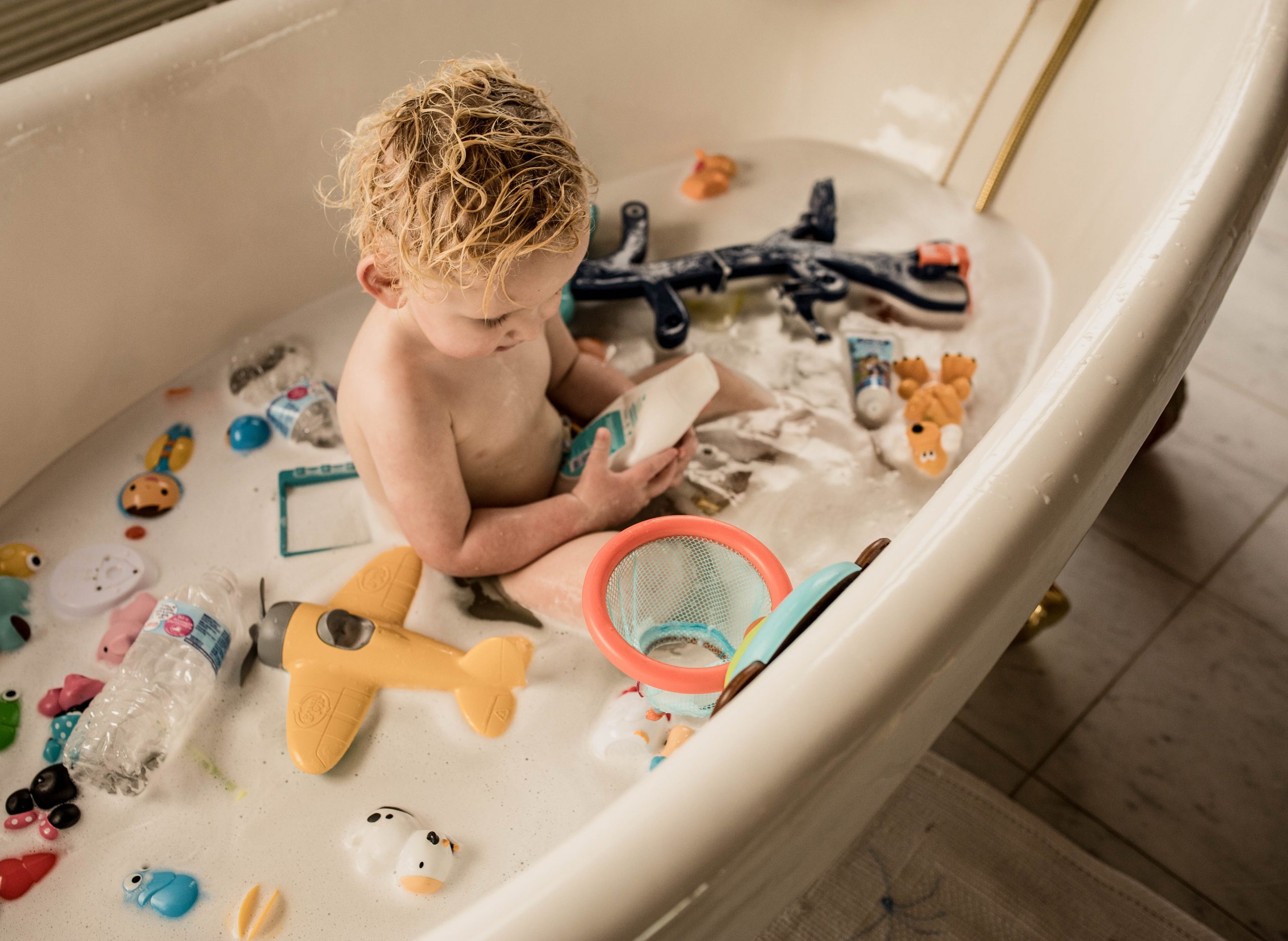 Toddler playing in the bathtub 