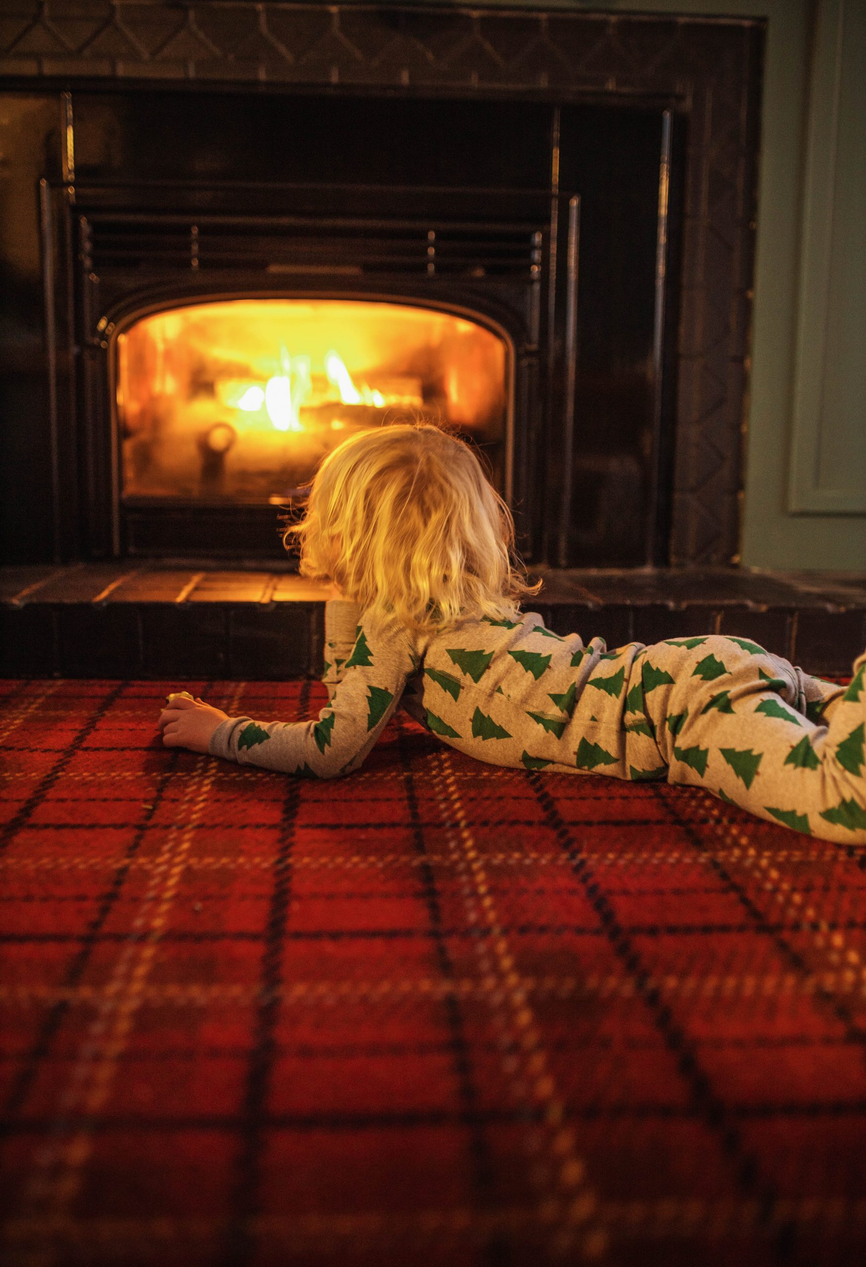 Child Sitting by the Fireplace